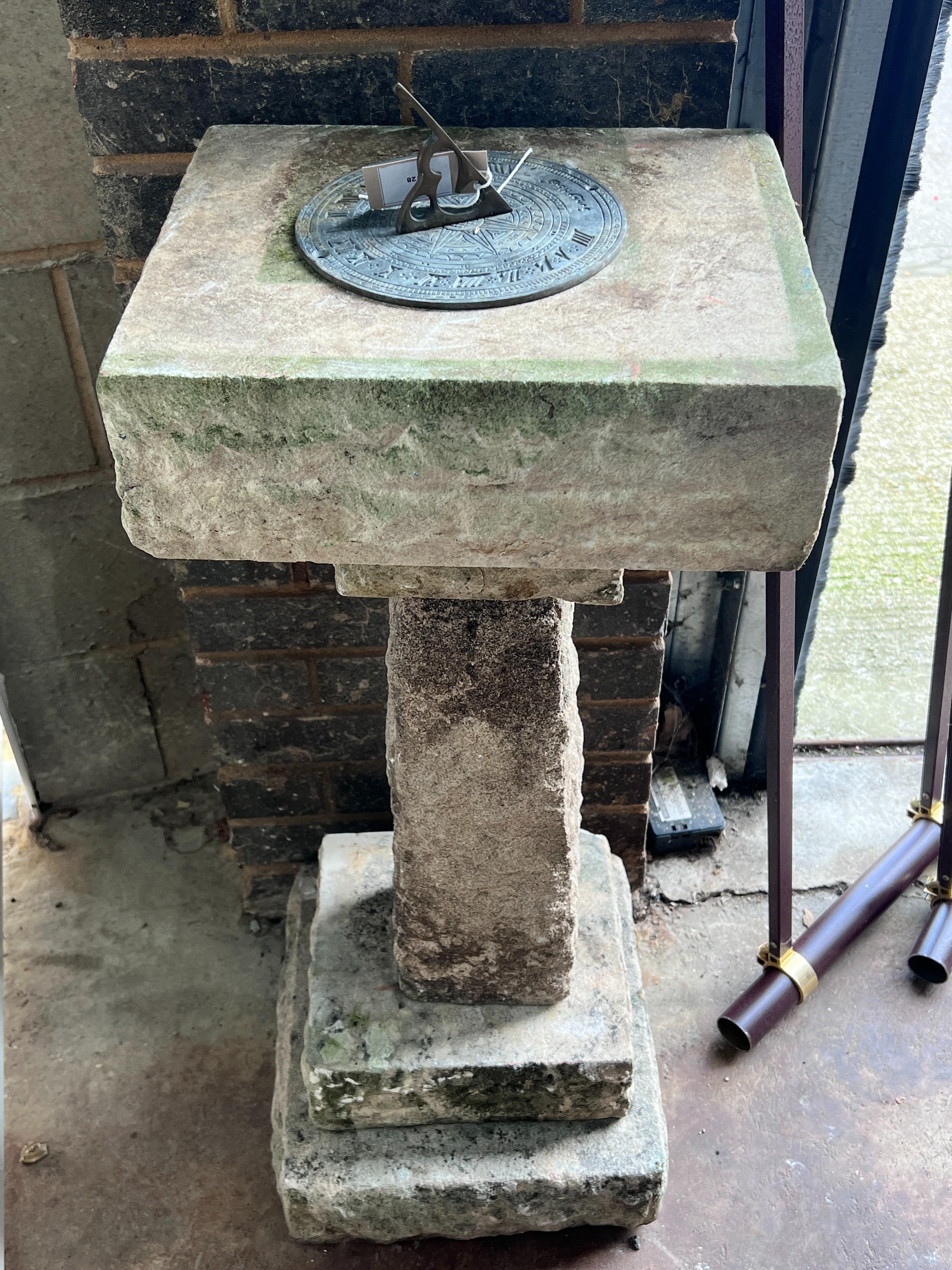 A sectional carved stone sundial with cast brass scale and gnomon, height 96cm